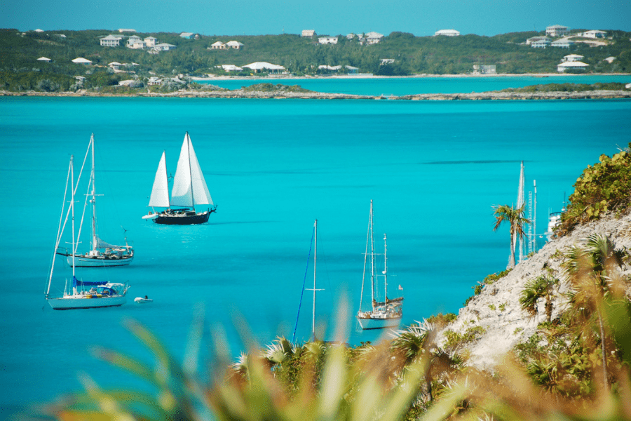 Sailboats travels past Stocking Island, Exuma, in the Bahamas